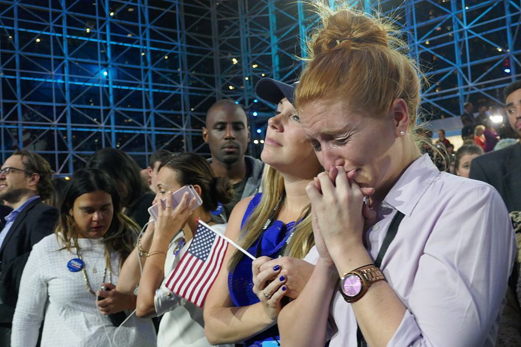 Democratic Party's presidential nominee Hillary Clinton's supporters show their sorrow as the results indicate the Republican Party's presidential nominee Donald Trump's victory for the 2016 Presidential Elections at Jacob K. Javits Convention Center in New York, NY, on November 9, 2016.