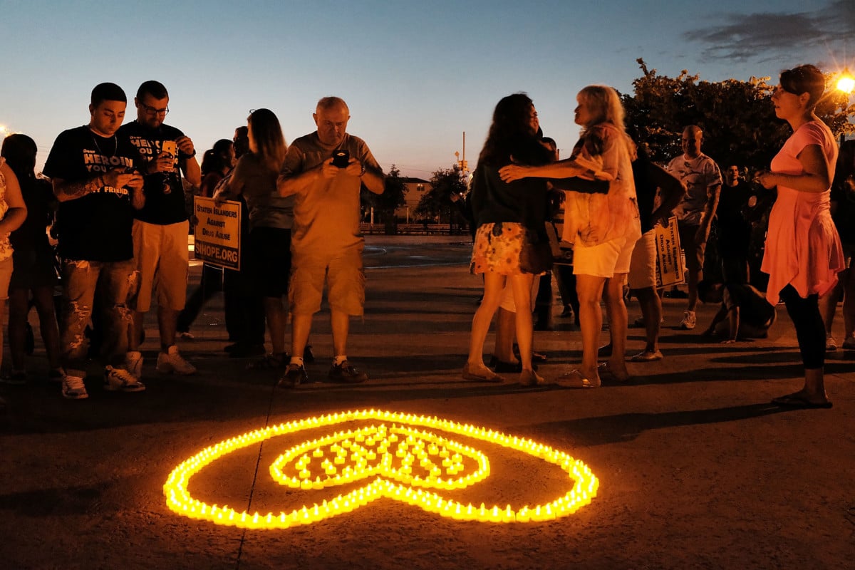 People attend a candlelight vigil for victims of opioid use on August 24, 2017 in the borough of Staten Island in New York City.