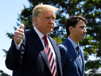 US President Donald Trump gives a thumbs up to the media as he is greeted by Prime Minister of Canada Justin Trudeau during the G7 official welcome at Le Manoir Richelieu on day one of the G7 meeting on June 8, 2018 in Quebec City, Canada.
