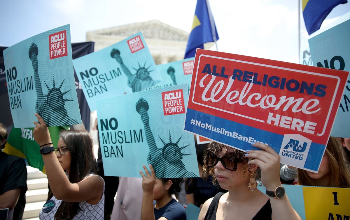 Protesters gather outside the US Supreme Court as the court issued an immigration ruling June 26, 2018, in Washington, DC. The court issued a 5-4 ruling upholding the Trump administration's policy imposing limits on travel from several primarily Muslim nations.