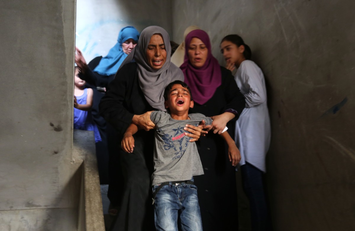 Relatives of a Palestinian, who was shot by Israeli forces during the 'Great March of Return' demonstrations, mourn during his funeral ceremony near Jabalia Refugee Camp in Gaza City, Gaza on July 24, 2018.