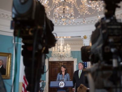 Secretary of State Mike Pompeo looks on as Ambassador to the United Nations Nikki Haley speaks at the US Department of State in Washington, DC, on June 19, 2018.