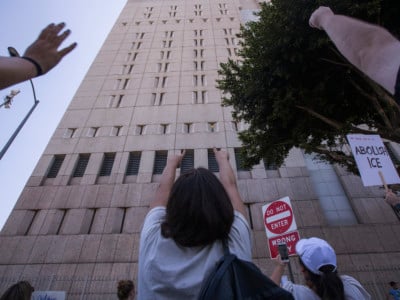 People call out words of encouragement to detainees held inside the Metropolitan Detention Center after marching to decry Trump administration immigration and refugee policies on June 30, 2018, in Los Angeles, California.
