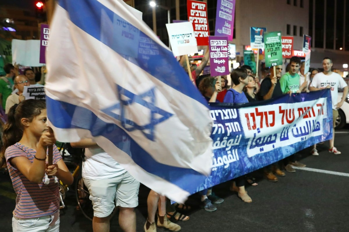 Demonstrators attend a rally to protest against the 'Jewish Nation-State Bill' in the Israeli coastal city of Tel Aviv on July 14, 2018.