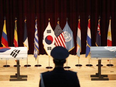 A South Korean honor guard stands in front of boxes containing the remains of United Nations Command (UNC) and South Korean soldiers who were killed in North Korea in the 1950-53 Korean War during the mutual repatriation ceremony of soldiers' remains between South Korea and US at the Seoul National Cemetery on July 13, 2018, in Seoul, South Korea.