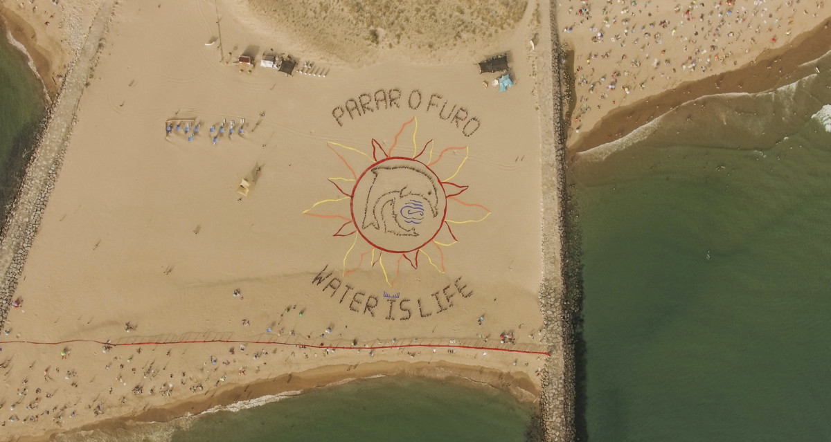 On August 4, about 800 people gathered at a beach near Lisbon, Portugal, to form a giant message saying, "Stop the oil drilling" and "Water is life."