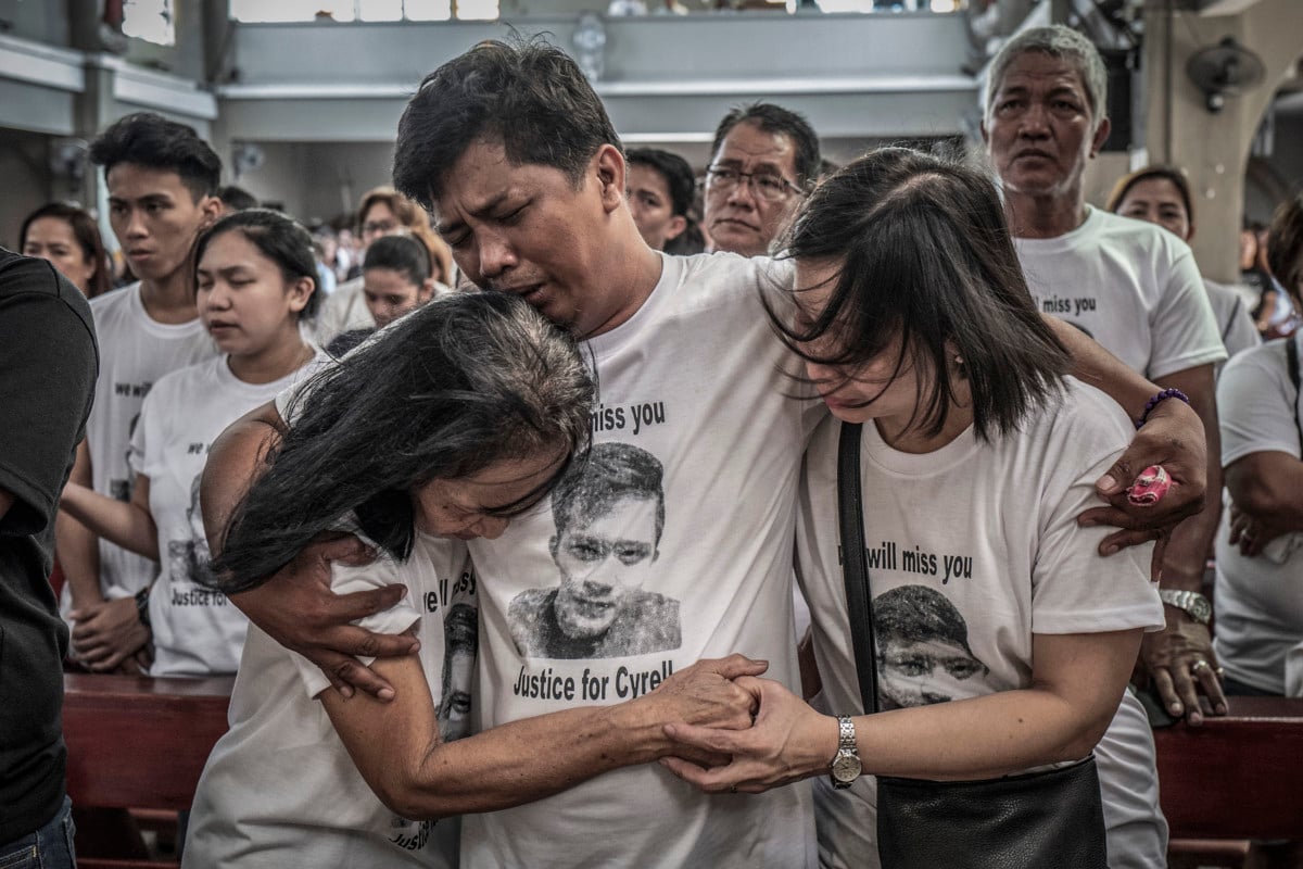 Mourners take part in the funeral of Jhan Cyrell Ignacio, a college freshman who was killed by unidentified gunmen, in Malabon, Metro Manila, in the Philippines on July 14, 2018. More than 27,000 have been killed as a result of a two-year war on drugs in the Philippines.
