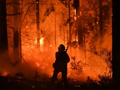 A firefighter tries to control a back burn as the Carr fire continues to spread towards the towns of Douglas City and Lewiston near Redding, California, on July 31, 2018.