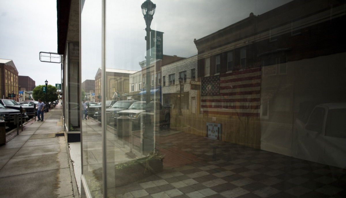 A USA flag hangs in the window of a vacant building in downtown Keyser, West Virginia.