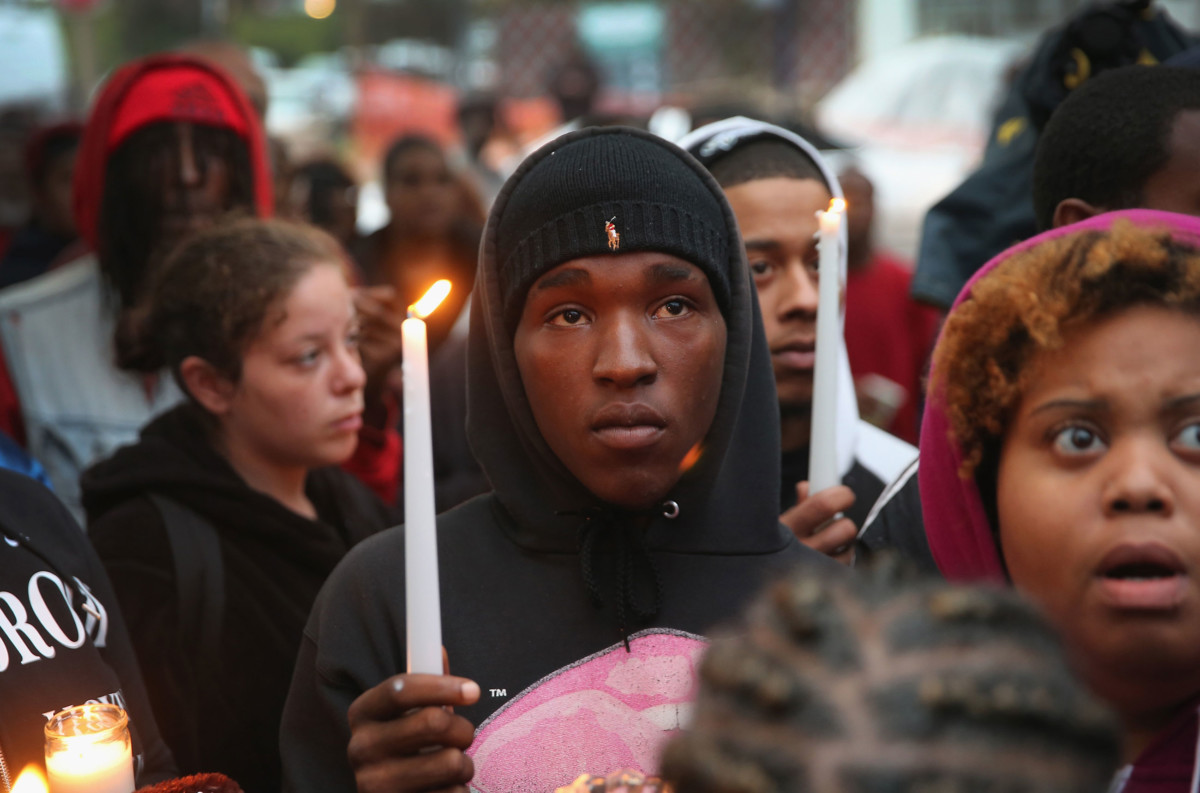 Mourners attend a candlelight vigil in memory of 18-year-old Vonderrit Myers Jr. on October 9, 2014, in St. Louis, Missouri. Meyers was shot and killed by an off-duty St. Louis police officer.