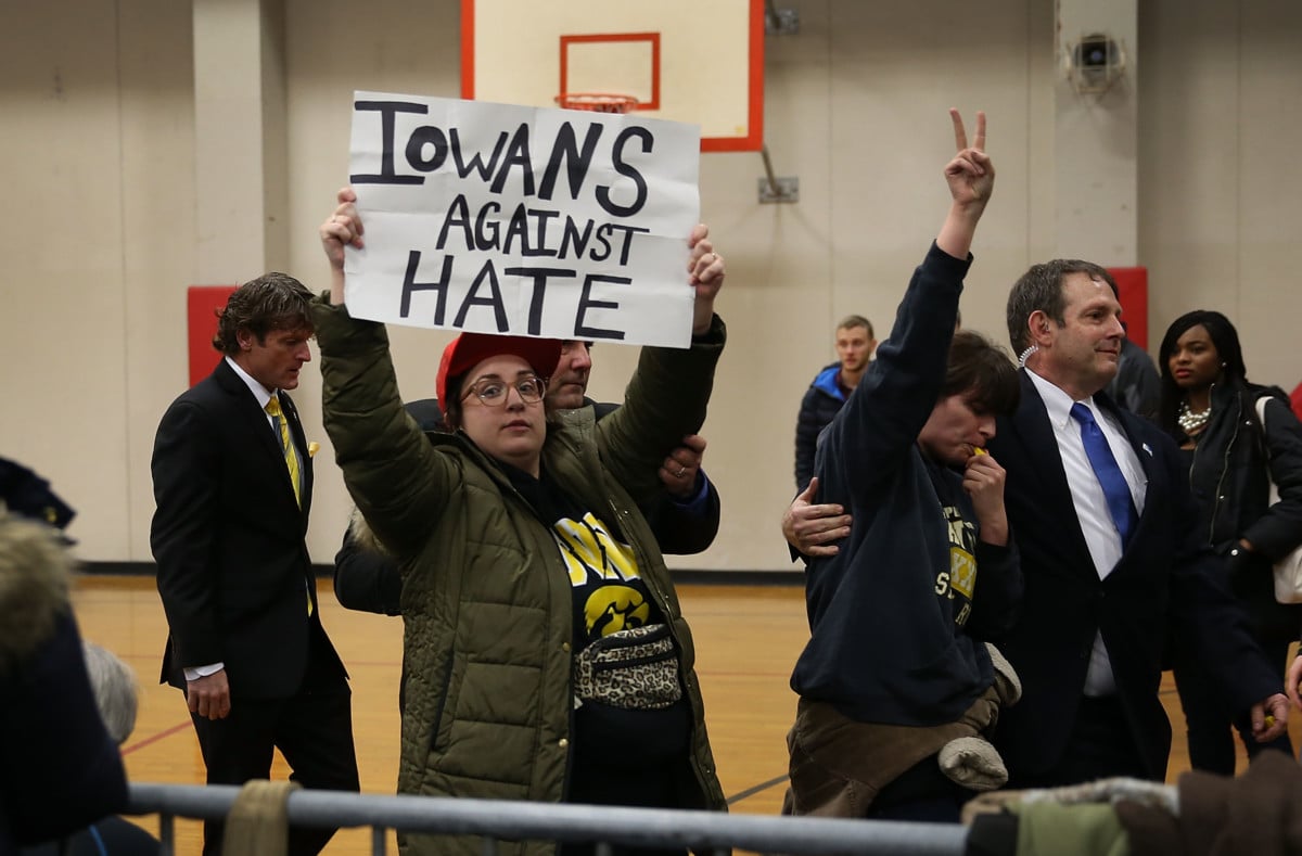 Protesters are escorted out after interrupting a Donald Trump campaign event at the University of Iowa, January 26, 2016.