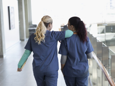 Two nurses walking down a corridor