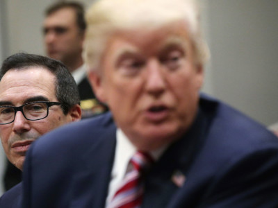 President Donald Trump speaks to business leaders as Secretary of the Treasury Steven Mnuchin looks on during a Roosevelt Room event October 31, 2017, at the White House in Washington, DC.