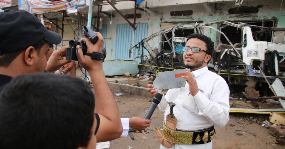 Yemeni journalist Ahmad Algohbary holds up a piece of the US-made bomb which killed 40 children last week.