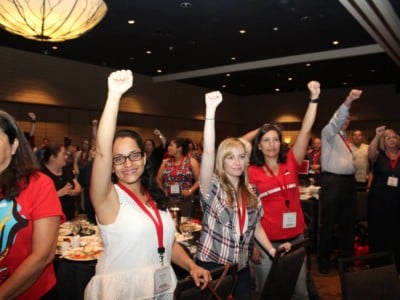Los Angeles educators raise their fists the All in For Respect Conference in August 2018.