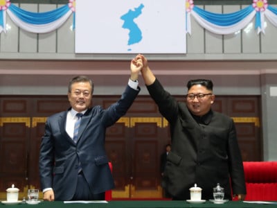 North Korean leader Kim Jong Un (right) and South Korean President Moon Jae-in (left) gesture as they watch a gymnastic and artistic performance at the May Day Stadium on September 19, 2018, in Pyongyang, North Korea.