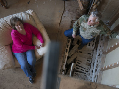 Sandra Landra and husband Gary stand where their fireplace used to be before an earthquake caused it to crumble in Prague, Oklahoma, on January 25, 2015. The Landras believe that wastewater injection wells used by oil companies are to blame for causing this quake as well as numerous others quakes throughout the state.