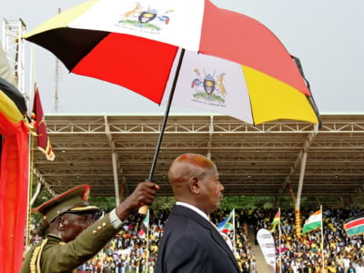 Uganda's President Yoweri Museveni stands under an umbrella during his swearing-in ceremony in Kampala on May 12, 2016.