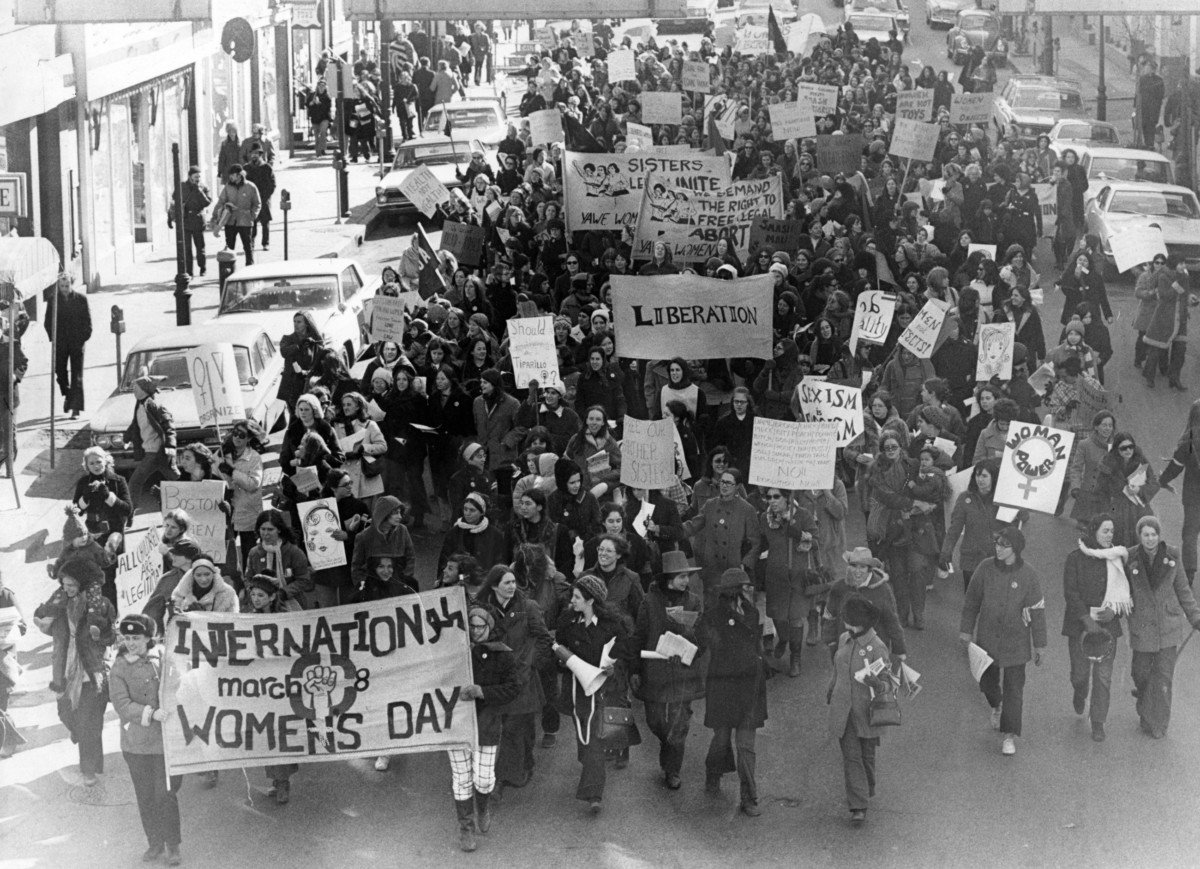 Protesting women led by the Bread and Roses group march along Beacon Street in Boston demanding rights to abortion and equality in work opportunities and conditions, March 8, 1970.