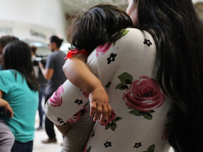 Dozens of women and their children, many fleeing poverty and violence in Honduras, Guatamala and El Salvador, arrive at a bus station following release from Customs and Border Protection on June 22, 2018, in McAllen, Texas.