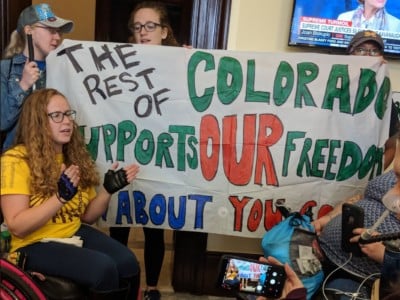 Members of ADAPT, a national grassroots disability rights organization, protest in the office of Sen. Cory Gardner (D-Colorado) on September 20, 2018.