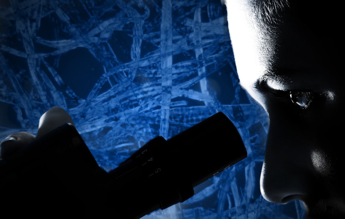 Scientist looking at microfibers in microscrope