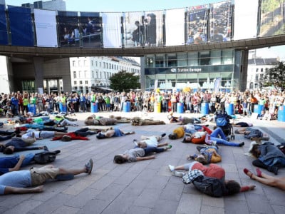 People lie down on the floor in a demonstration to draw attention to global warming and climate change outside of the European Parliament building in Brussels, Belgium on October 6, 2018.