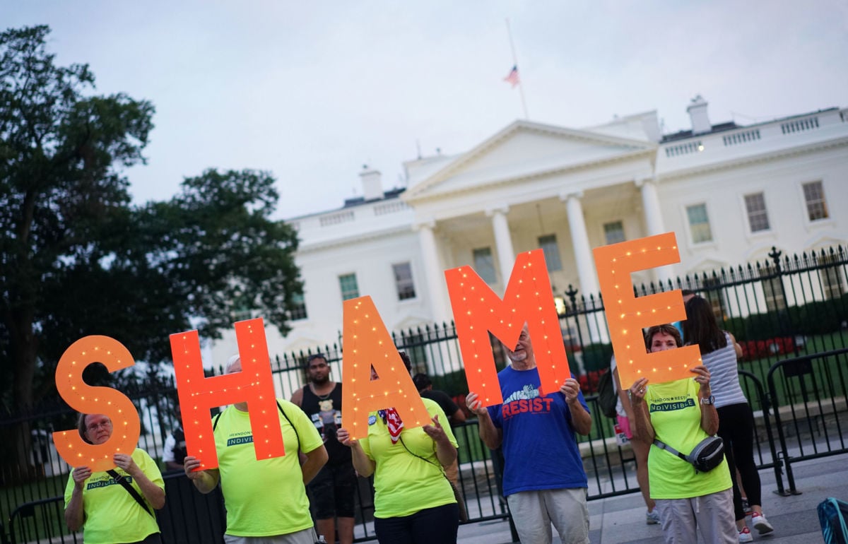 Demonstrators protesting against President Donald Trump are seen in front of the White House in Washington, DC, on August 27, 2018.