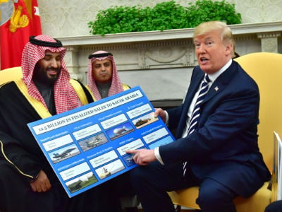 President Trump holds up a chart of military hardware sales as he meets with Crown Prince Mohammed bin Salman of the Kingdom of Saudi Arabia in the Oval Office of the White House on March 20, 2018, in Washington, DC.