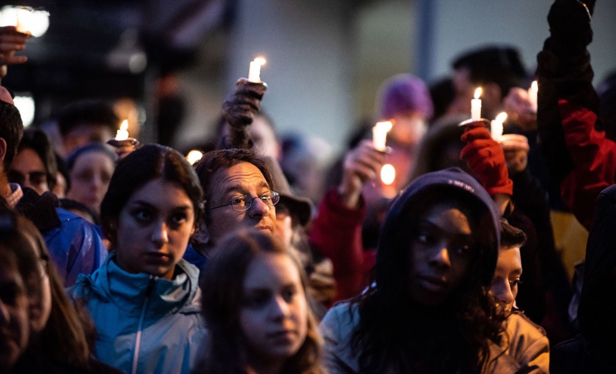 Mourners are seen holding candles in the aftermath of the mass shooting at the Tree of Life Synagogue in Squirrel Hill, Pittsburgh, Pennsylvania.