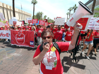Teachers march through downtown Phoenix on their way to the State Capitol during a rally for the #REDforED movement on April 26, 2018, in Phoenix, Arizona.
