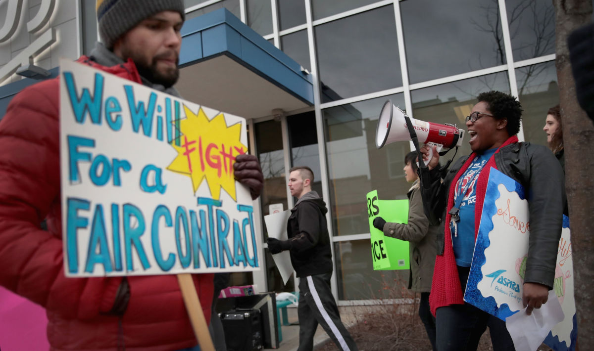 Teachers with ASPIRA charter school network chant during a rally outside an ASPIRA high school on March 9, 2017, in Chicago, Illinois, which almost lead to the nation's first strike at a privately run charter school last year.