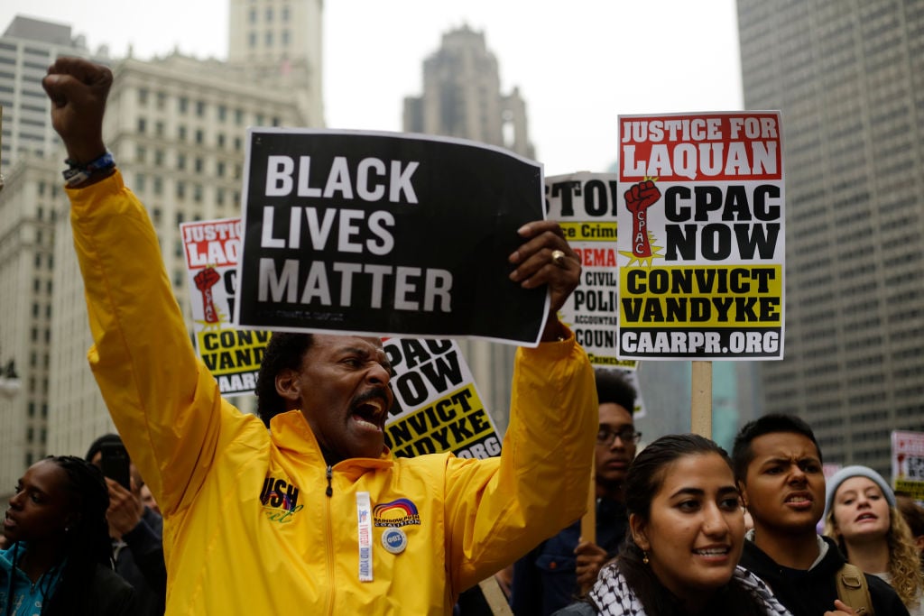 Demonstrators protest as they celebrate the verdict in the murder trial of Chicago police officer Jason Van Dyke along Michigan Avenue on October 5, 2018, in Chicago, Illinois.