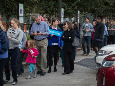 People wait in line to vote at a polling place on the first day of early voting on October 22, 2018, in Houston, Texas.