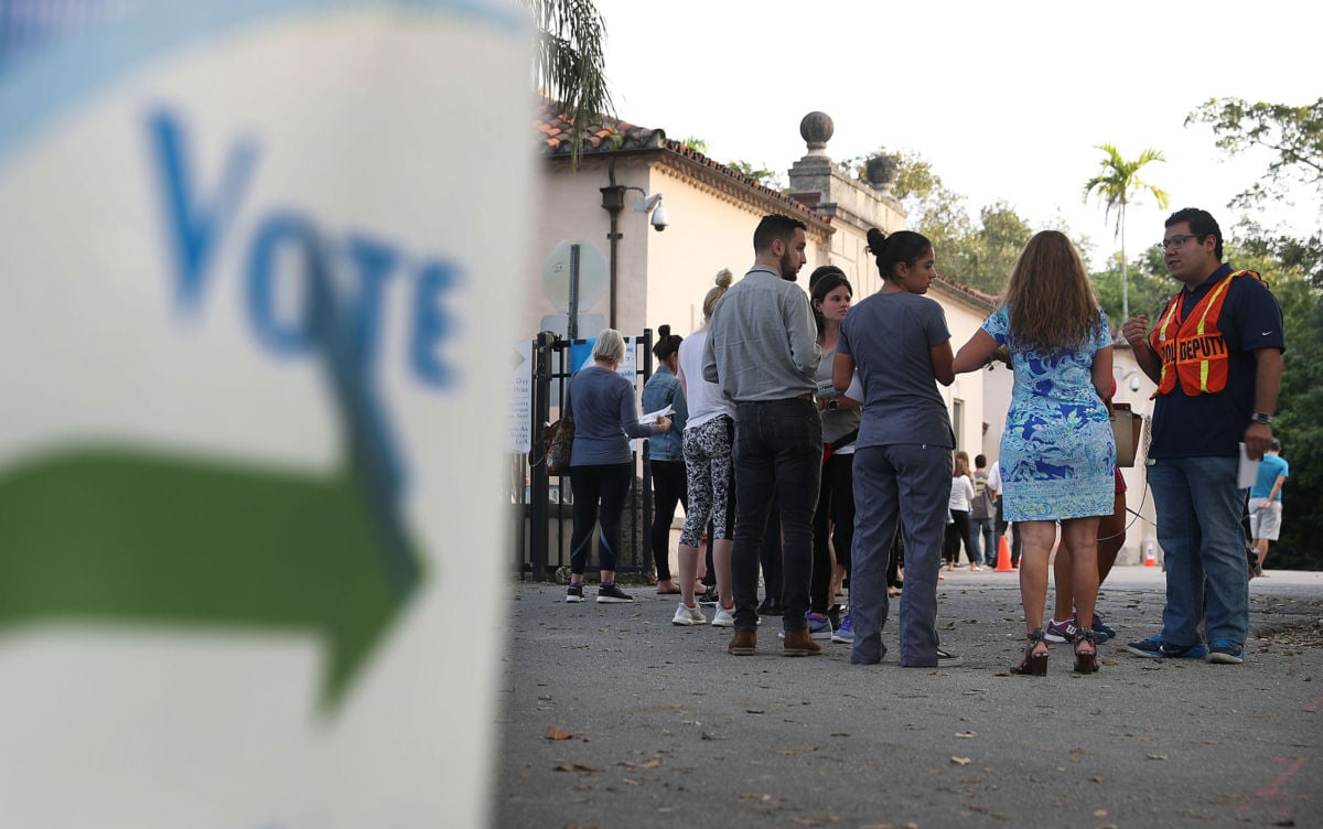 Voters line up to cast their ballot just before the polls open in the mid-term election on November 6, 2018, in Miami, Florida.
