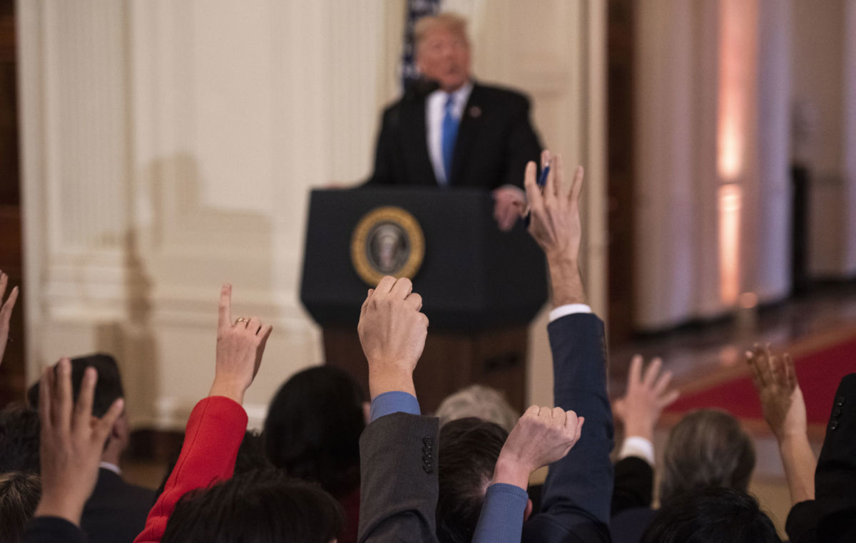 Reporters raise their hands to ask President Trump questions during a press conference in the East Room of the White House in Washington, DC, on November 7, 2018.