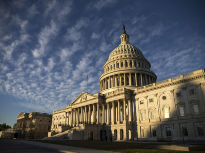 A photo of the US Capitol building in Washington, DC. It's a rectangular white building with a large dome in the center.