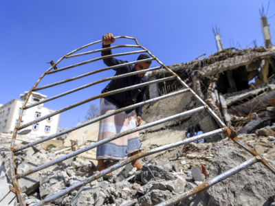 A Yemeni man goes through the wreckage of a building that was reportedly destroyed in a Saudi-led coalition airstrike in the capital Sanaa on September 5, 2018.