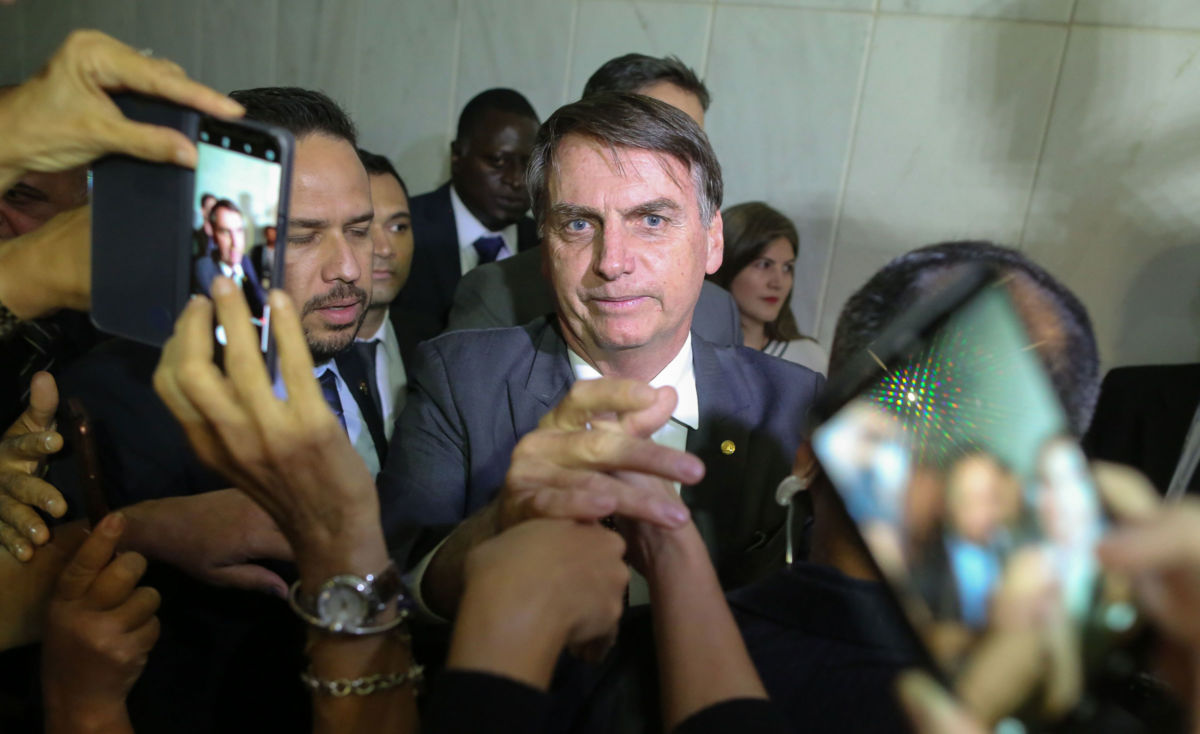 Brazil's President-elect Jair Bolsonaro greets people during his visit to the Superior Court of Labour in Brasilia, on November 13, 2018.