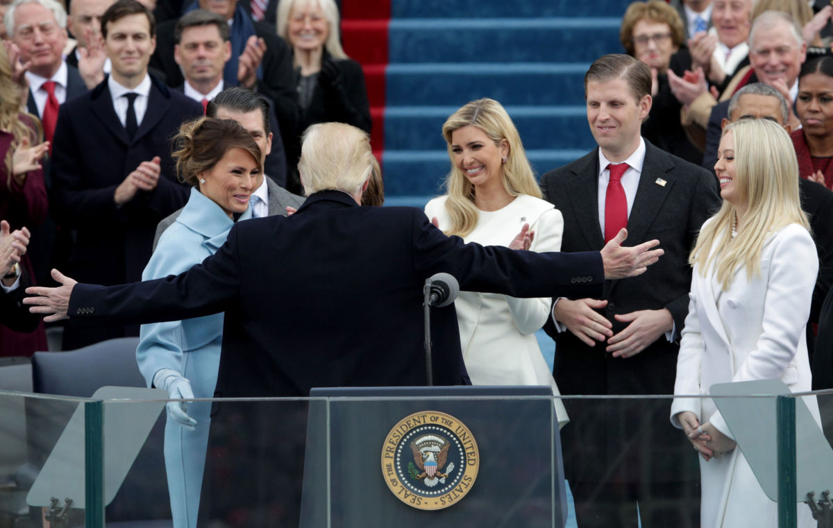 President Trump reaches for an embrace as First Lady Melania Trump, Ivanka Trump, Eric Trump and Tiffany Trump look on after his inauguration on the West Front of the US Capitol on January 20, 2017, in Washington, DC.