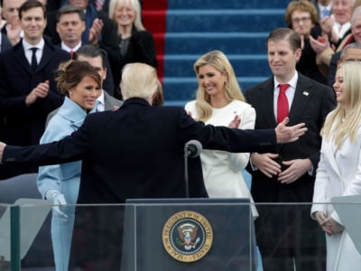 President Trump reaches for an embrace as First Lady Melania Trump, Ivanka Trump, Eric Trump and Tiffany Trump look on after his inauguration on the West Front of the US Capitol on January 20, 2017, in Washington, DC.