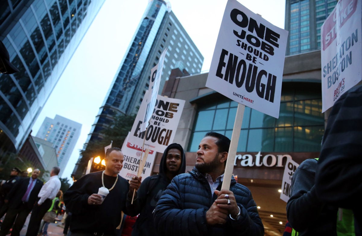 Workers and supporters picket outside the Sheraton Boston by Marriott in Boston on October 3, 2018. Building the world anew under a new social order is the hardheaded realism the working class must face.