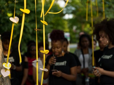 As part of the Chicago Park District's Night Out in the Parks, A Long Walk Home's Girl/Friends artists and activists speak in front of the "Healing Tree," a special tribute to the living memory of Rekia Boyd and recently missing Black girls, on July 26, 2018..