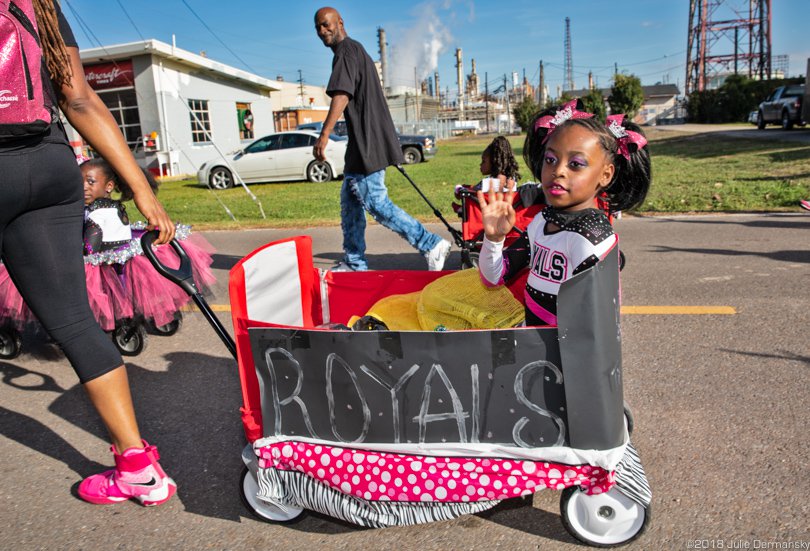 Children in wagons pass a Shell refinery in Norco, Louisiana, during the 2018 annual Christmas Parade in the heart of Cancer Alley.