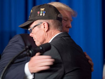 Donald Trump hugs Vietnam veteran Max Morgan as he participates in a veterans meet and greet on the sidelines of the Asia-Pacific Economic Cooperation leaders' summit in the central Vietnamese city of Danang on November 10, 2017.