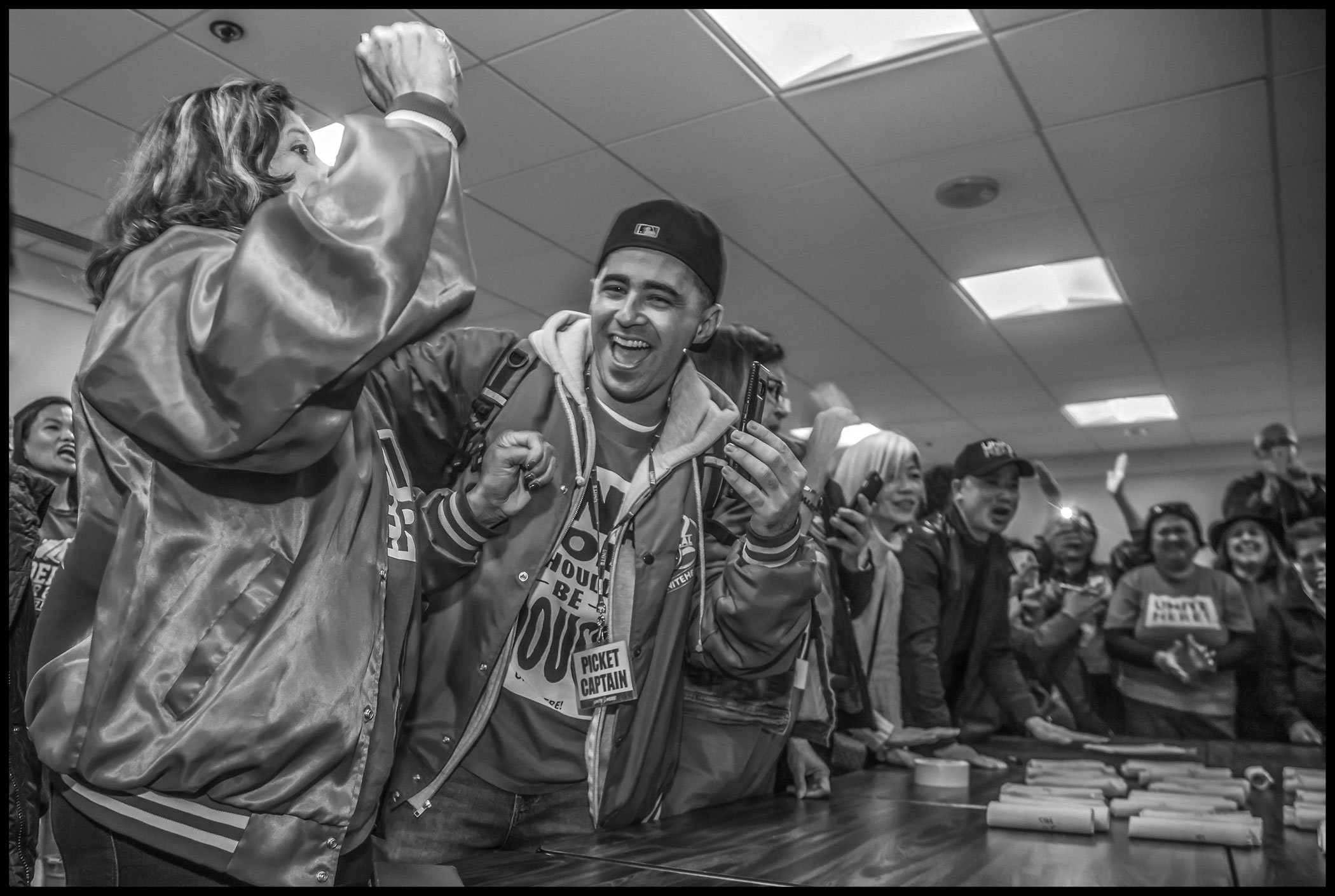 The vote to ratify the contract is almost unanimous, with only a handful of votes against and over a thousand in favor. Workers cheer when the vote total is announced.