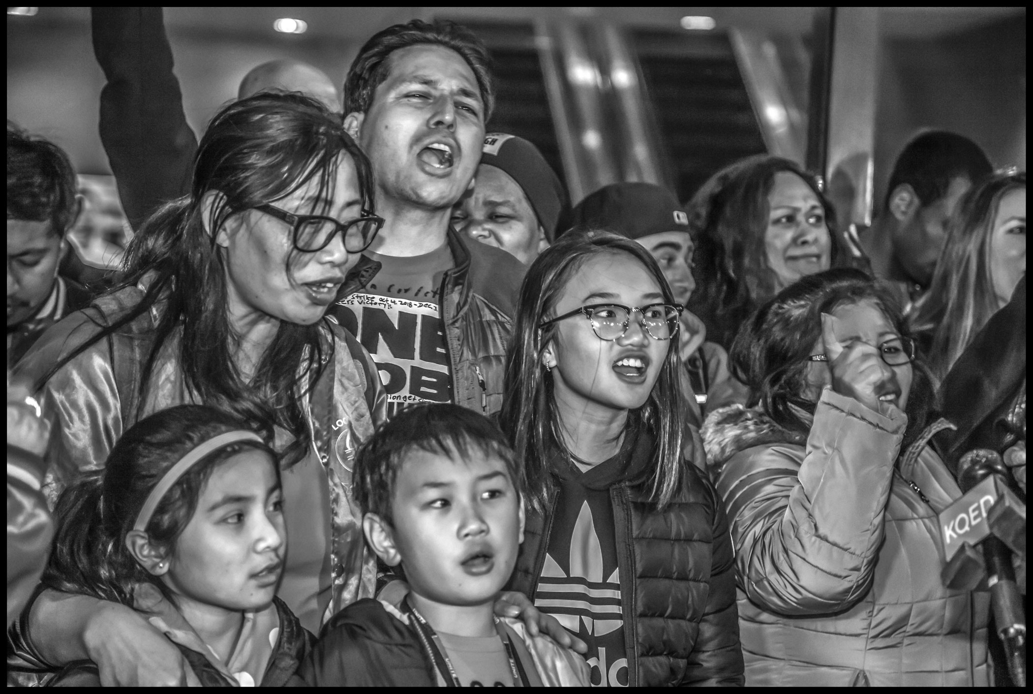 Outside the contract ratification meeting strikers cheer during a press conference to announce the results.