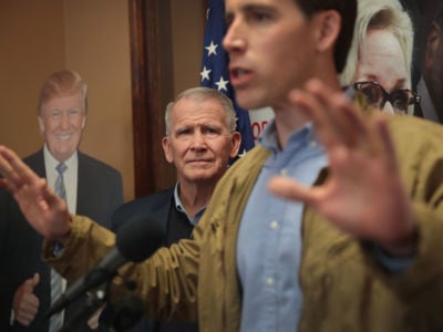 NRA President Oliver North (L) listens as Republican Senate candidate Josh Hawley speaks to supporters during a campaign stop at the Jefferson County GOP office on November 3, 2018, in Imperial, Missouri.