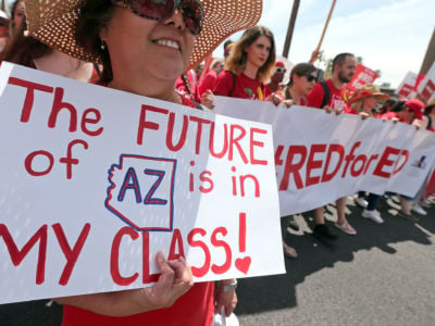 Arizona teachers march toward the State Capitol to demand fully funded schools on April 26, 2018, in Phoenix, Arizona.