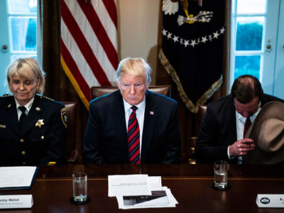 President Trump bows his head during a prayer as he participates in a roundtable discussion on border security with state, local and community leaders in the Cabinet Room on the 21st day of the partial government shutdown at the White House on Friday, January 11, 2019, in Washington, DC.